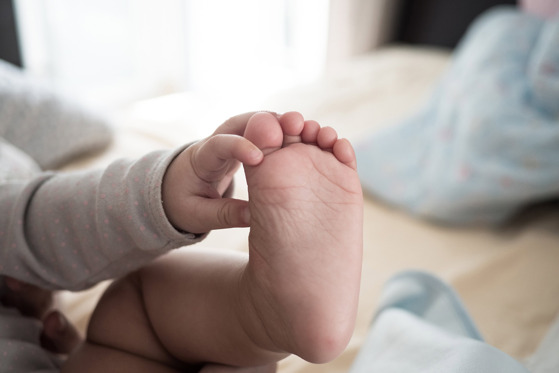 low section child with feet up lying bed home